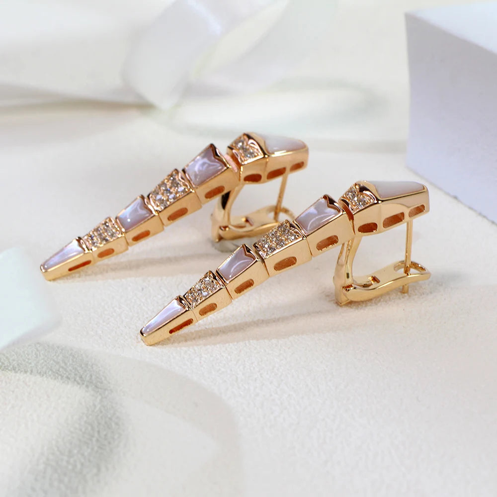 a pair of rose gold earrings with gemstones