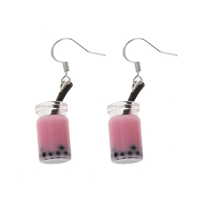  a pair of bubble tea earrings with a pink liquid 