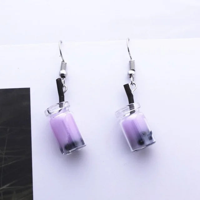  a pair of bubble tea earrings with a purple liquid