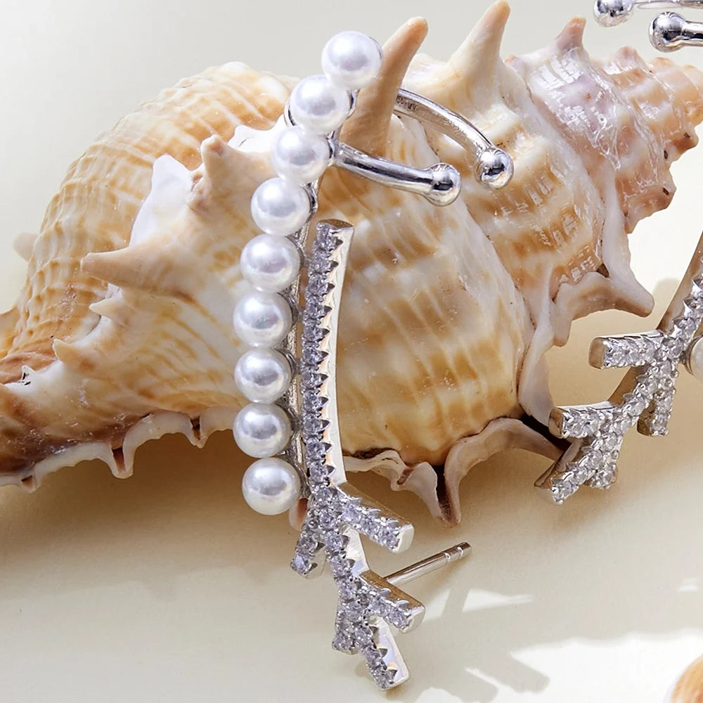 a creative closeup of a silver earring with pearls and gemstones