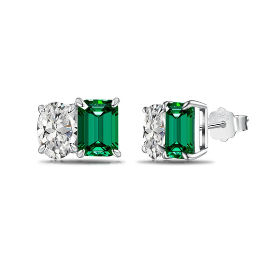 a pair of earrings with green and white stones on a white background