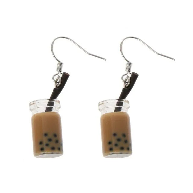 a pair of bubble tea earrings with a brown/coffee liquid