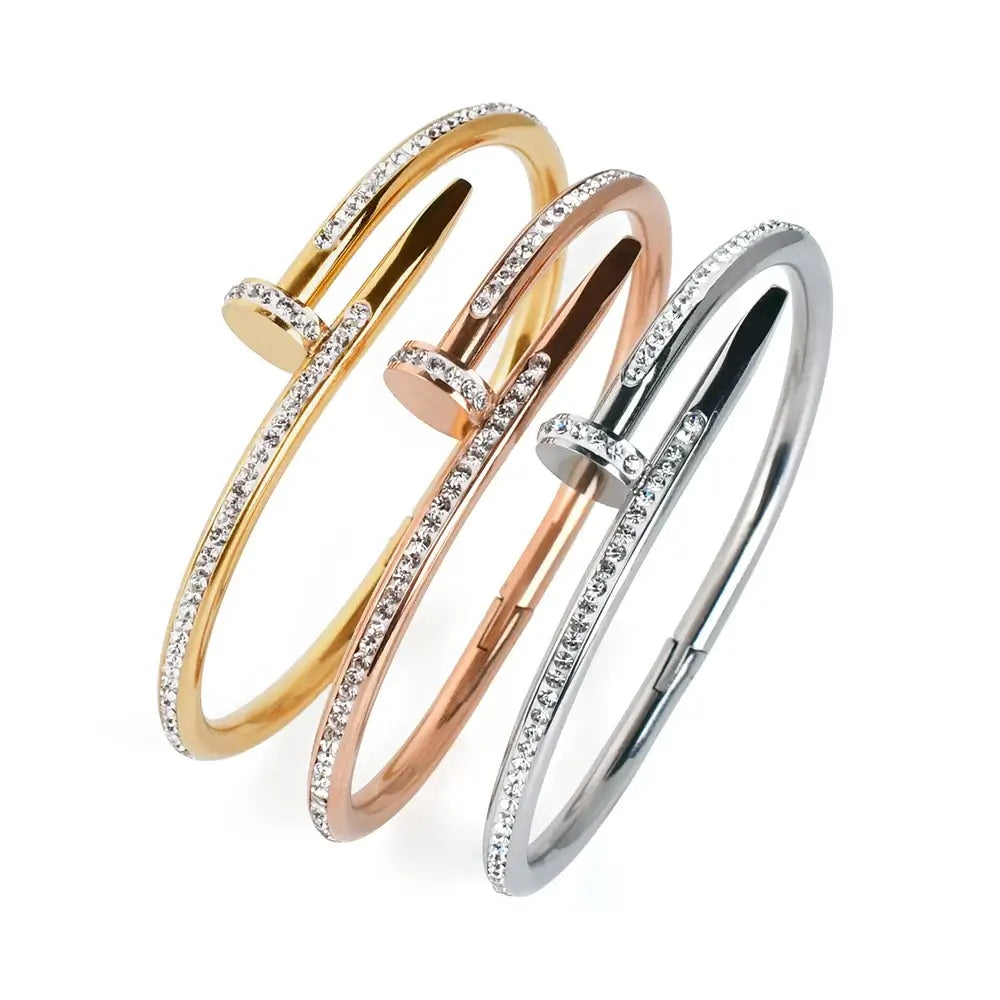 a silver, rose gold and gold variant of a design bracelet next to eachother