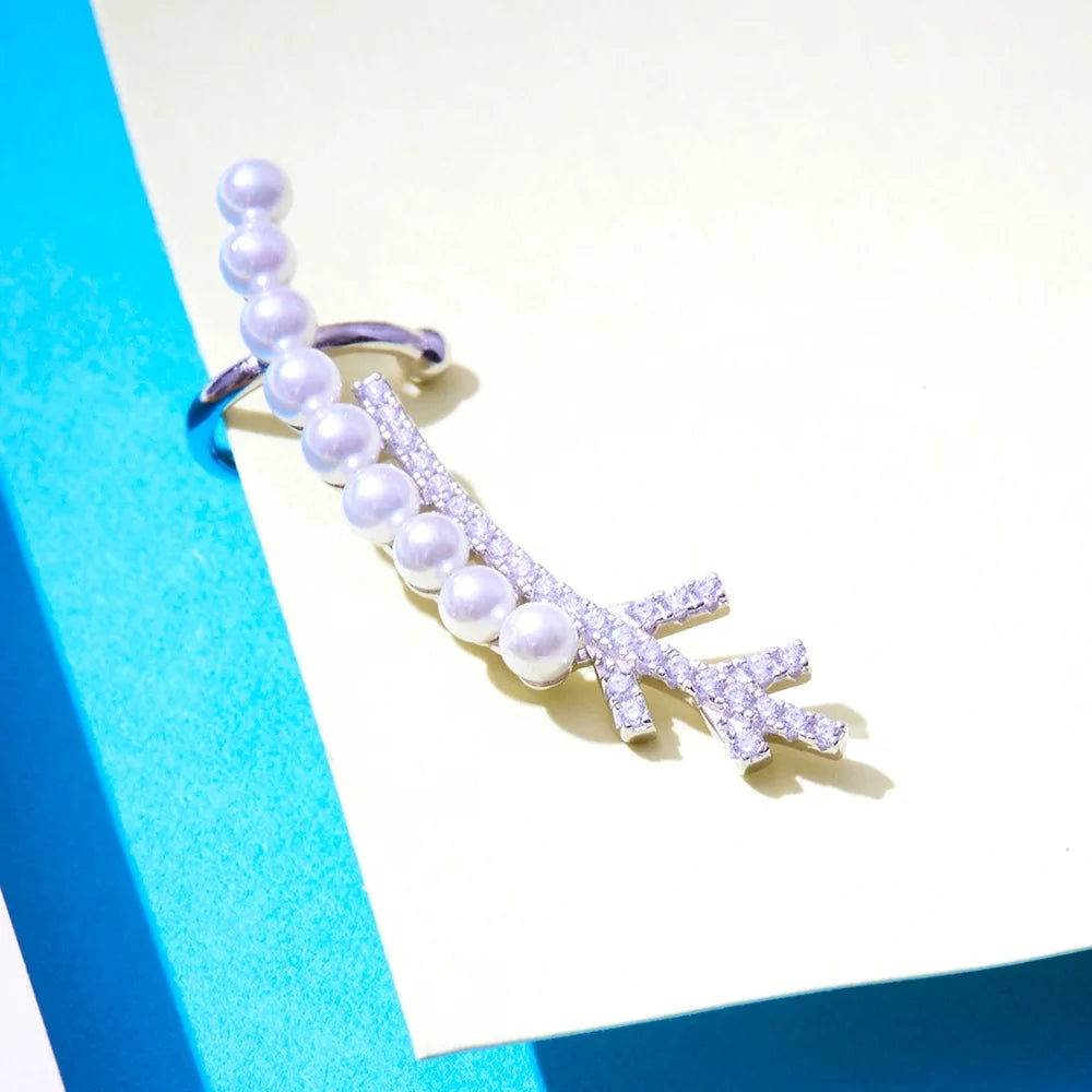another perspective of a silver earring with pearls and gemstones