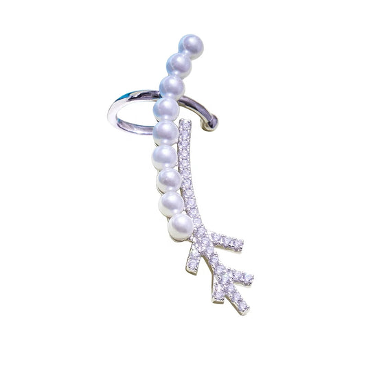 a silver earring with pearls and gemstones
