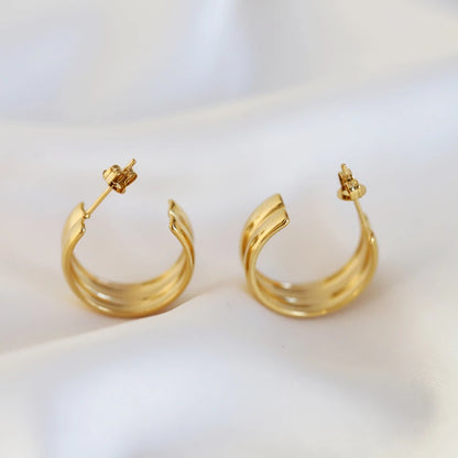another perspective of a pair of gold hoop earrings