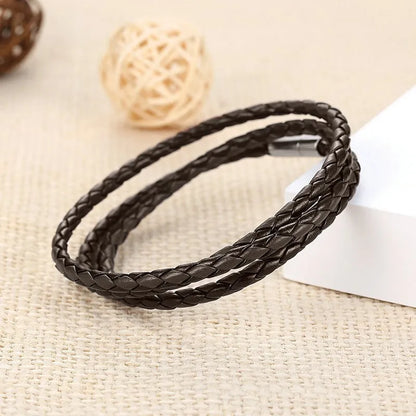 a black leather bracelet laying on a table