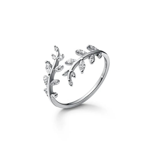 a silver leaf design ring on a white background