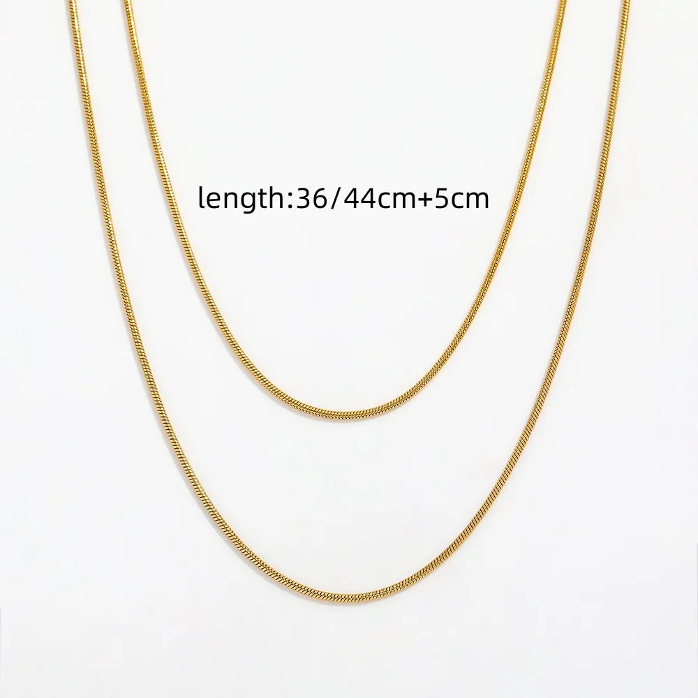 a gold necklace with measurements besides it