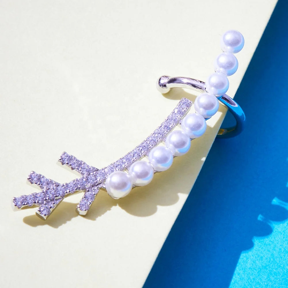 closeup of a silver earring with pearls and gemstones