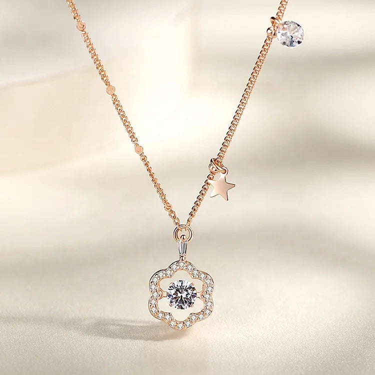 a rose gold necklace with a pendant and a star
