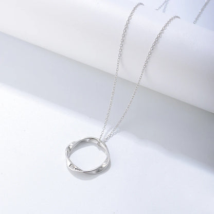 a silver necklace with a twisted ring on it