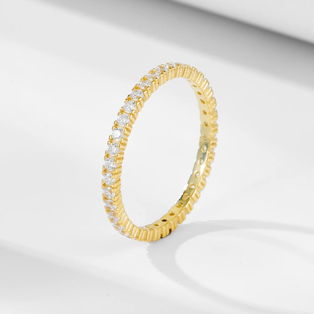 a gold ring set with fine gemstones all around