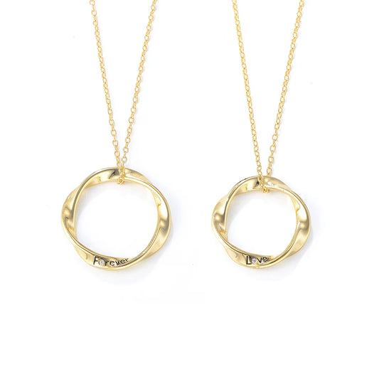 a pair of gold necklaces with a couple of rings