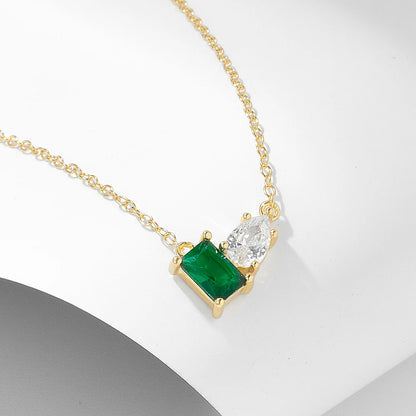 a golden necklace with a green and white gemstone