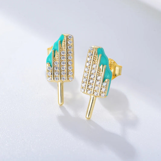 a pair of golden ice cream shaped earrings with blue enamel and gemstones