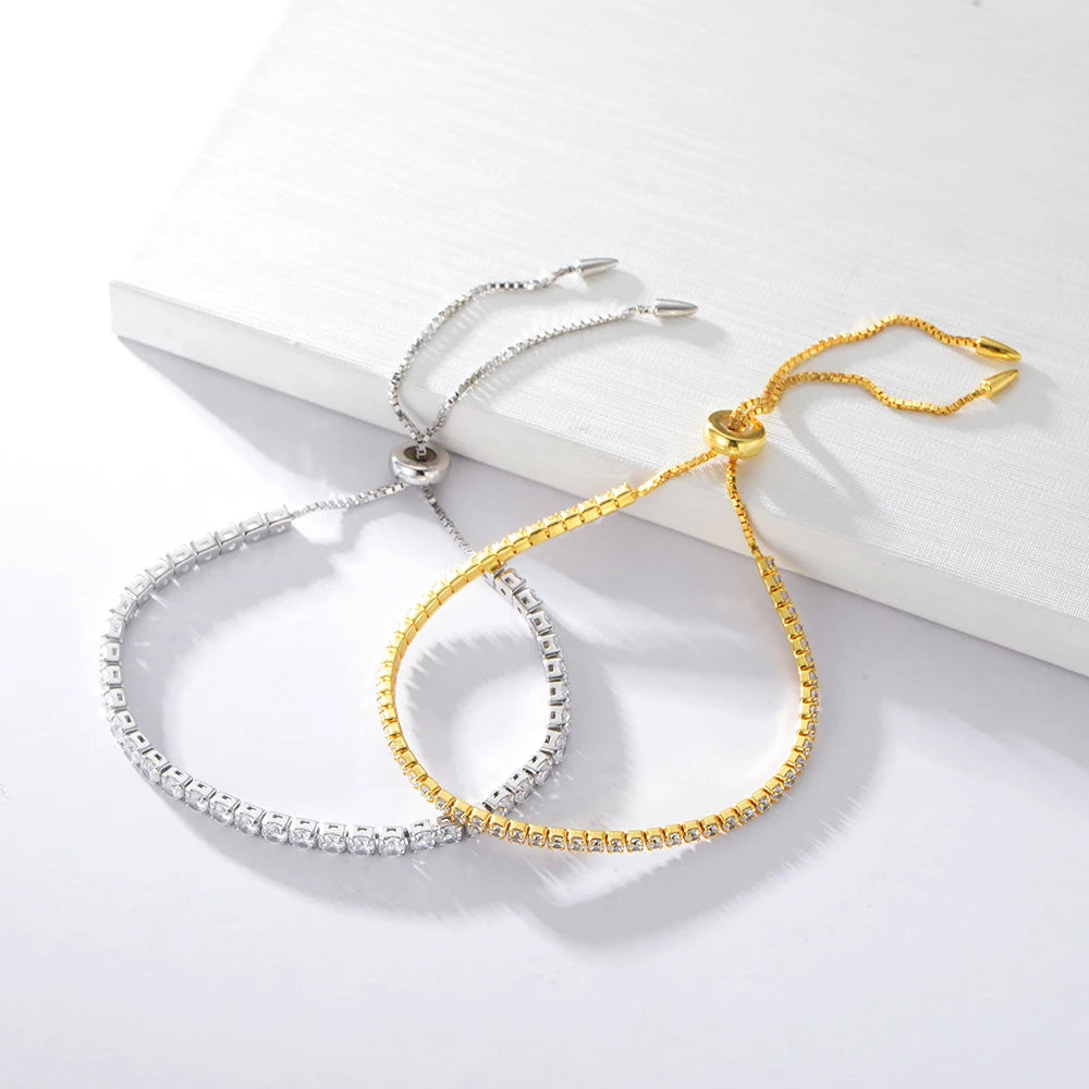 a pair of gold and silver bracelets
