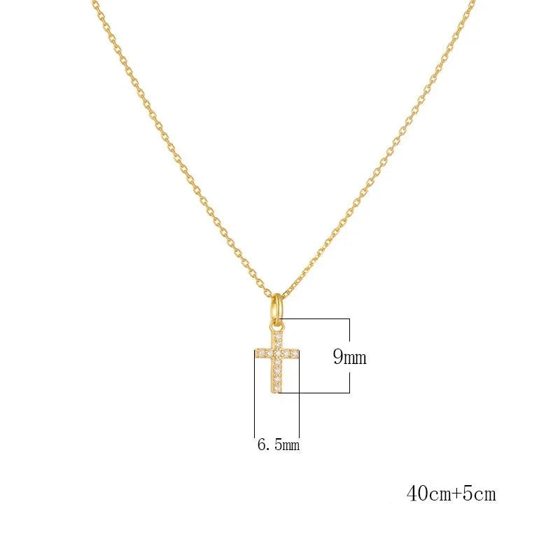 a gold necklace with a cross pendant and measurements next to it
