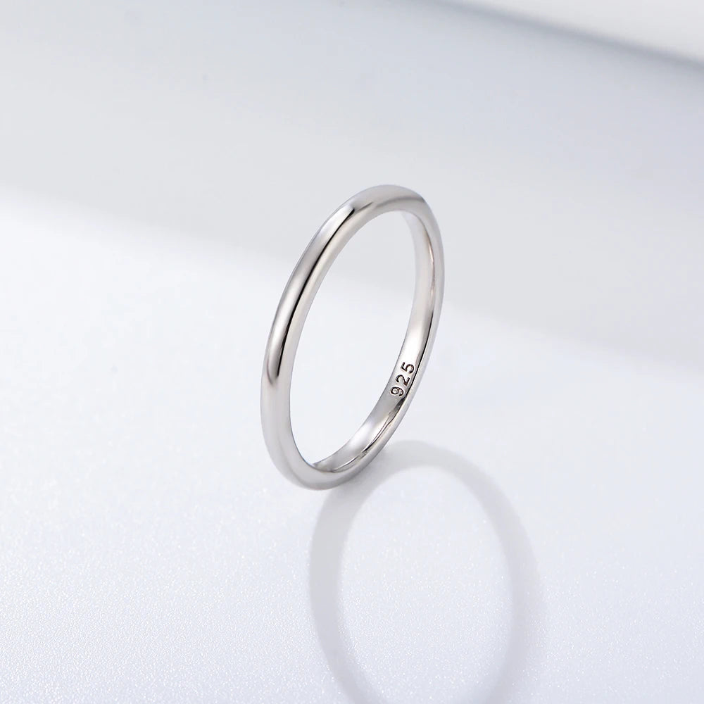 a plain silver ring on a white surface