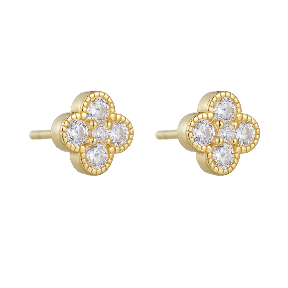 a pair of gold clover shaped earrings with a white background