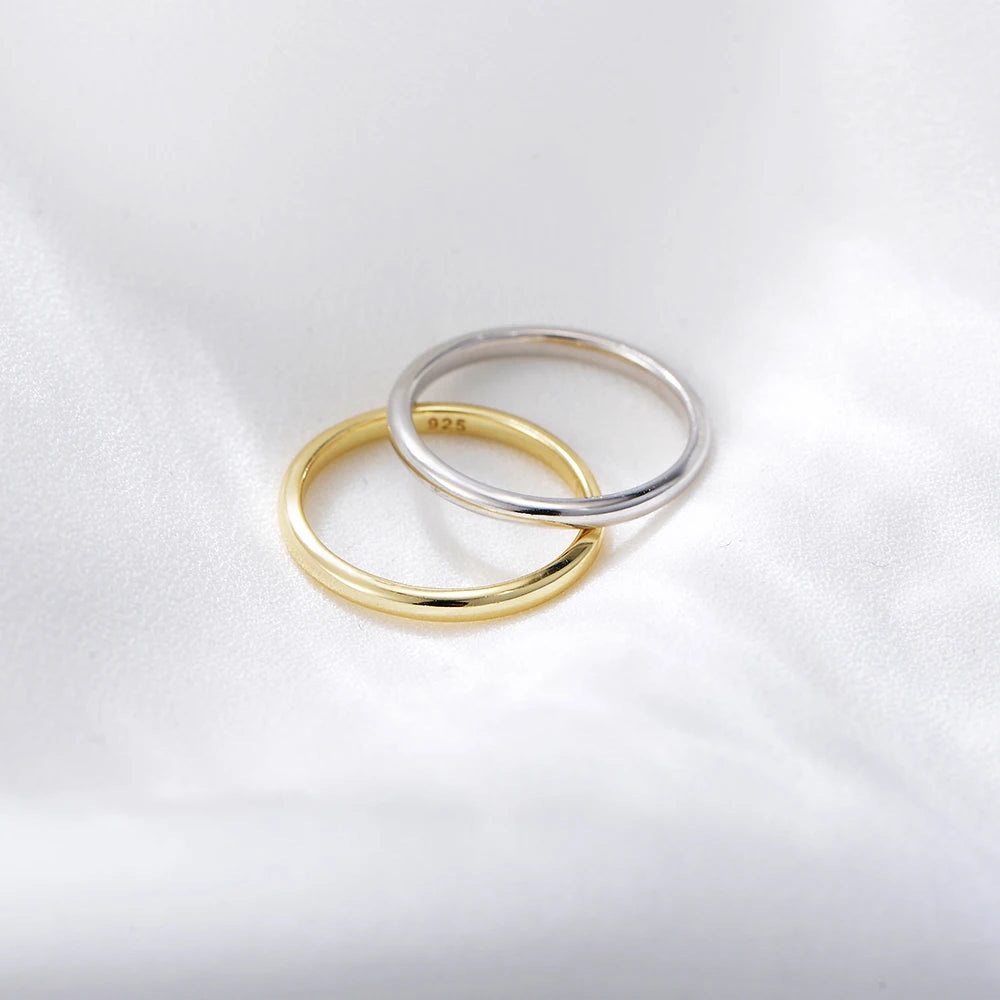 a pair of plain gold and silver rings