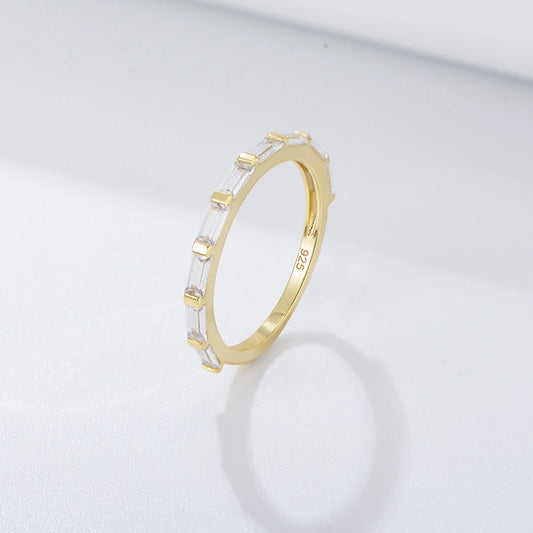 a gold ring with a row of rectangle gemstones on it